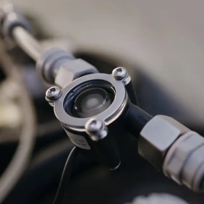 The Flowmeter fitted inline on a water line, with its transparent top showing the rotor