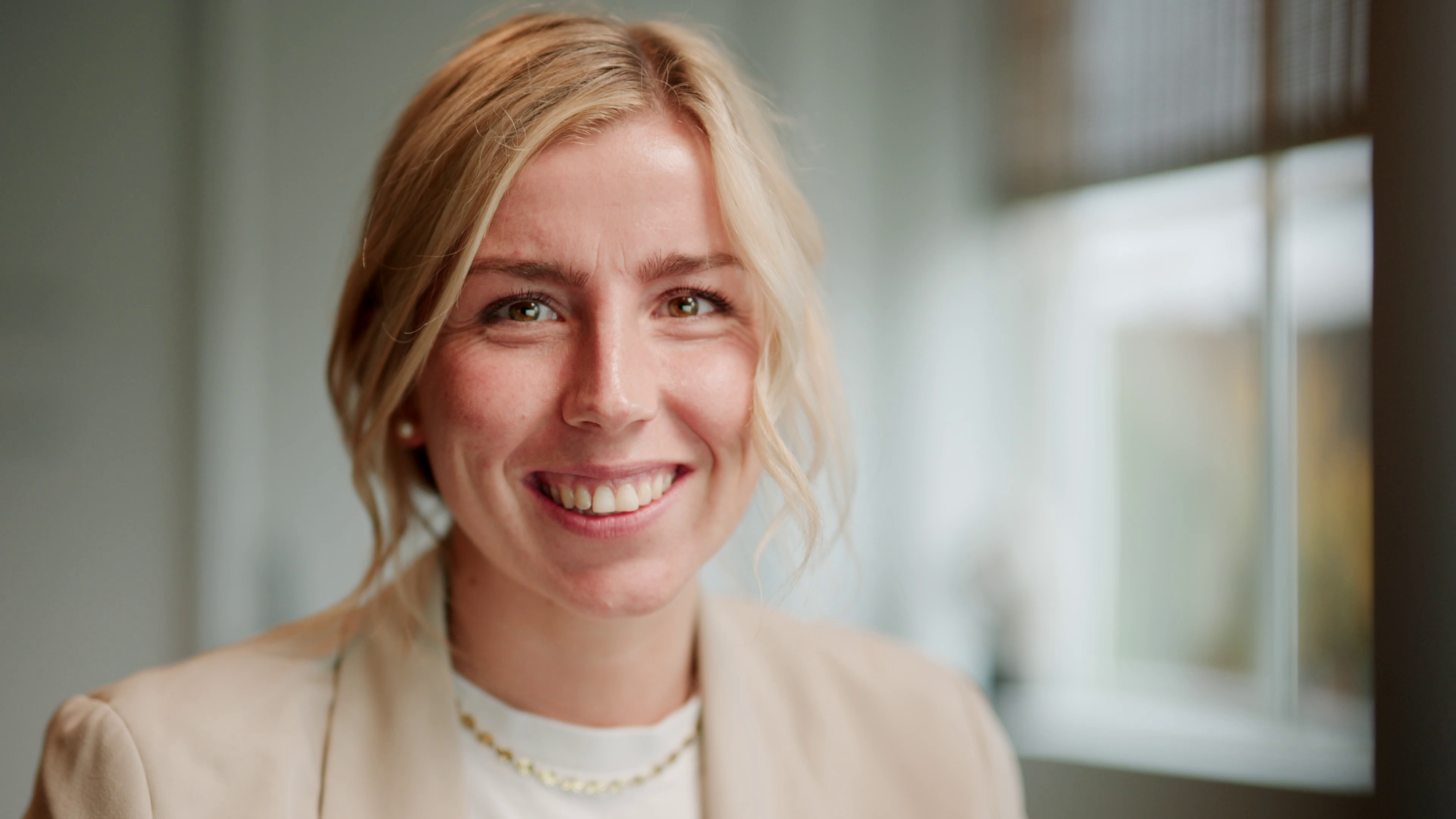 A Flowplan colleague smiling in a bright office