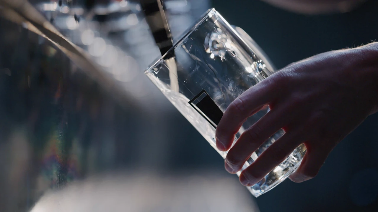 Film: a beer is poured and set down on a bar, closing on the words 'Digitalization made easy'.